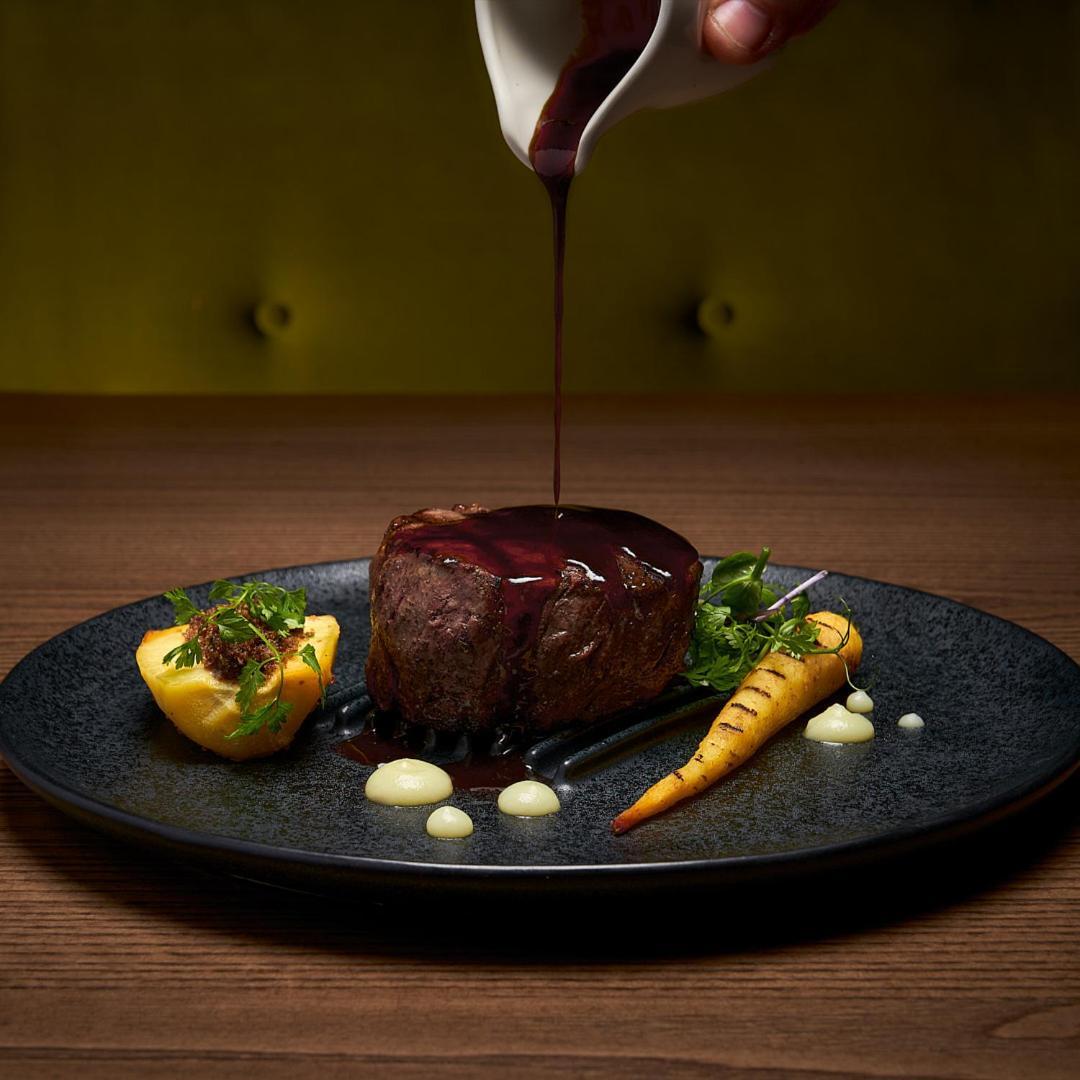 The G Hotel & Spa Galway Exterior foto A steak being drizzled with a port wine sauce
